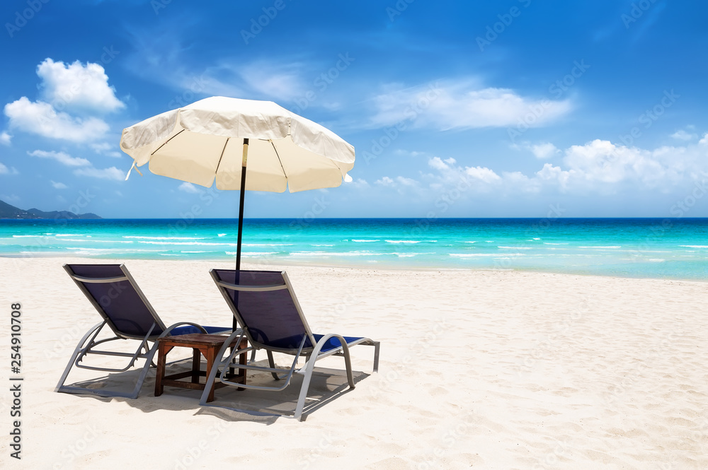 Beach chairs with umbrella and beautiful sand beach