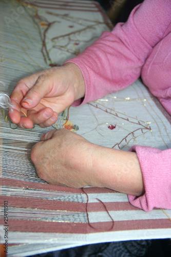 A senior woman sewing and making crafts in her home
