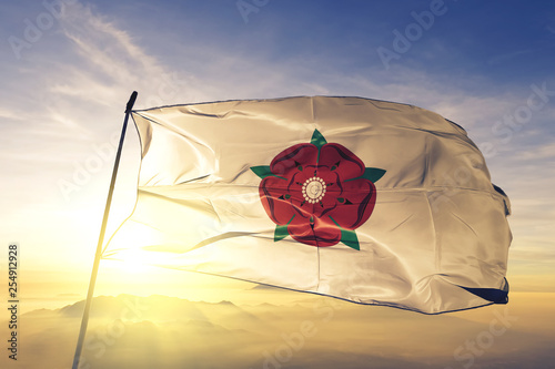 Lancashire county of England flag waving on the top sunrise mist fog photo