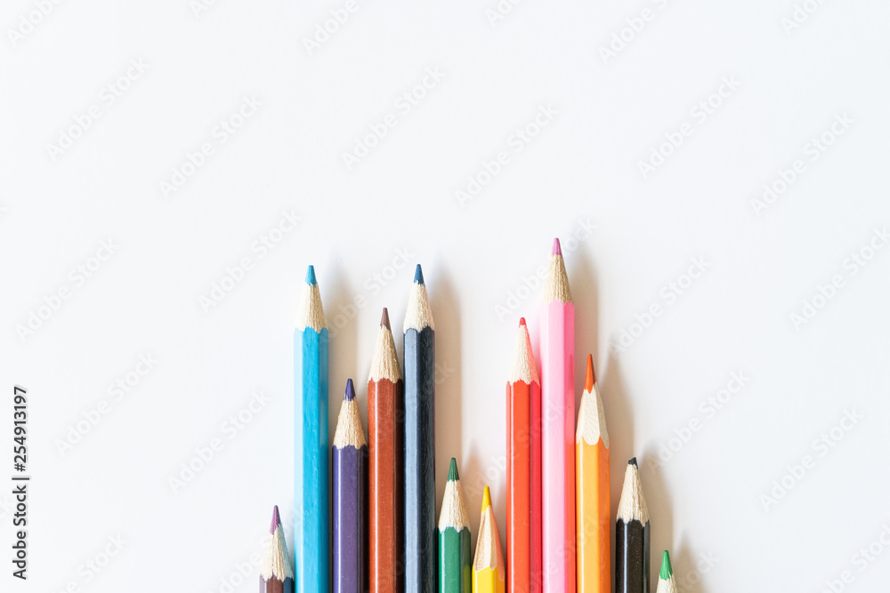 Fototapeta premium Color pencils for drawing on the center on white background