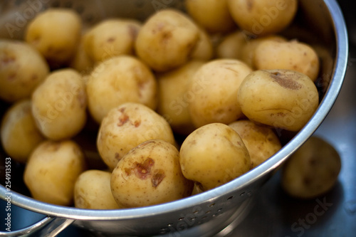 Boiled potatoes draining in a colander