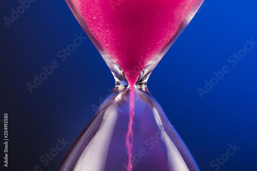 Bright colored pink sand with hourglass