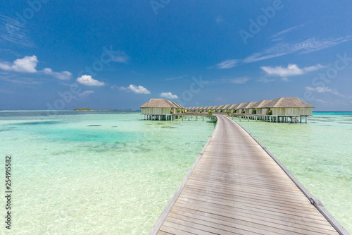 Landscape of Maldives beach. Tropical panorama, luxury water villa resort with wooden pier or jetty. Luxury travel destination background for summer holiday and vacation concept