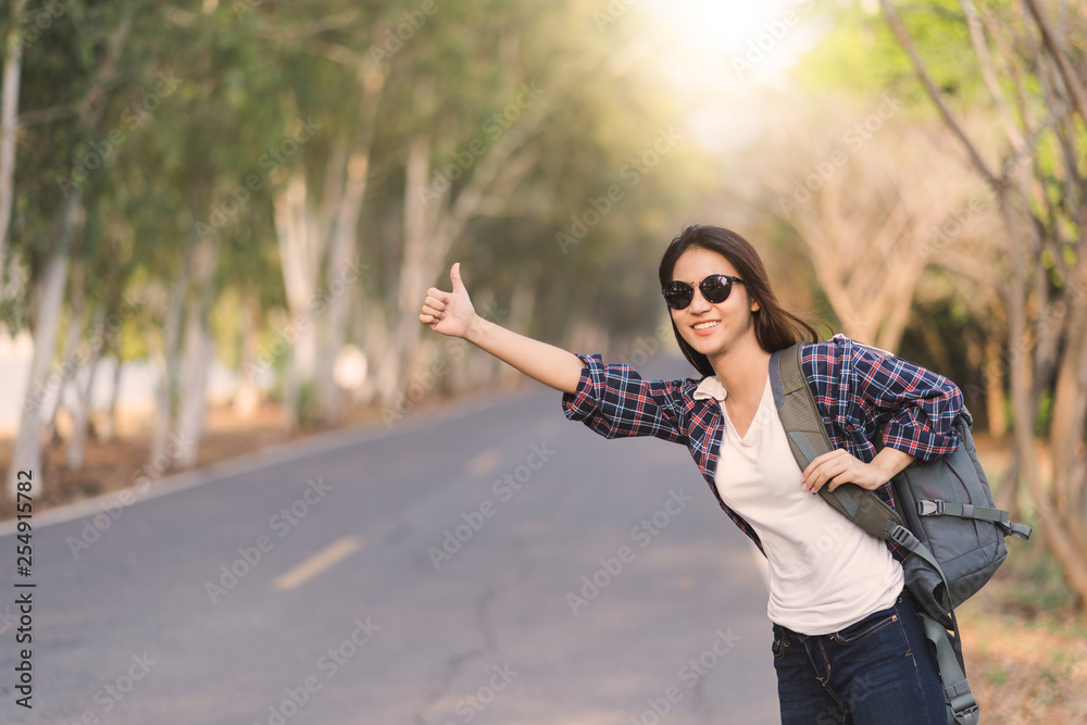 Portrait of a young attractive happy Asian woman traveler backpacker background with copy space