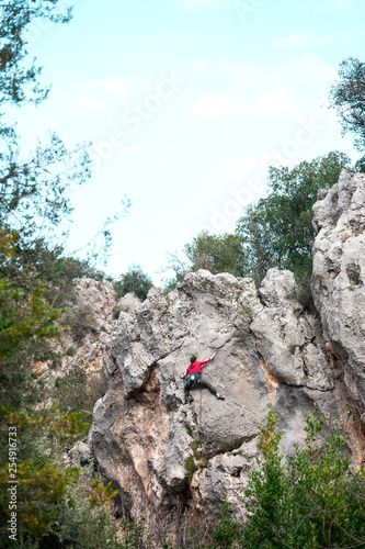 A girl climbs a rock.