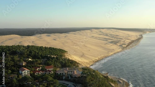 Drone flies over the largest sand dune in Europe. Aerial of the enormous Dune du Pilat extends beyond Le Pilat Plage