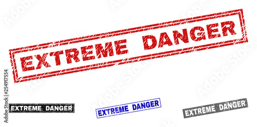 Grunge EXTREME DANGER rectangle stamp seals isolated on a white background. Rectangular seals with grunge texture in red, blue, black and grey colors.