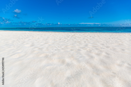 Empty beach scenery, white sand blue sky and blue sea. Tropical beach landscape background. Summer vacation and holdiay