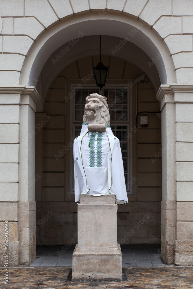 Lion sculpture dressed in an embroidered shirt.
