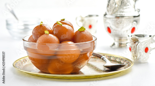 Delicious Gulab Jamuns in crystal bowl photo