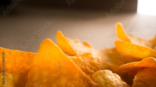 Golden nachos chips on a craft paper box