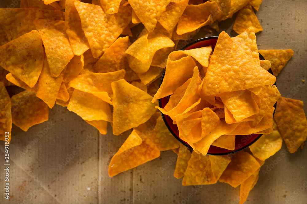 Golden nachos chips on a craft paper box Golden nachos chips on a craft paper box