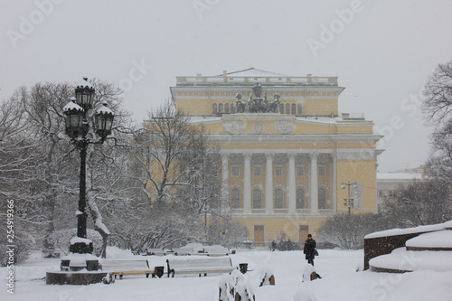 Alexandrinsky theatre on Ostrovsky square and city park view with snow in St. Petersburg, Russia. Russian Pushkin Drama theater facade architecture and local town square picturesque winter scene photo