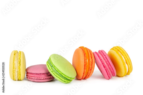 Colorful french macaroons in row isolated on white