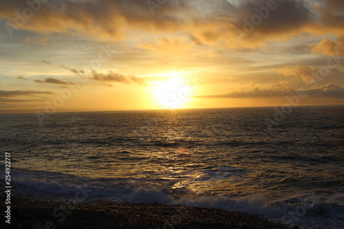 Sunset over the ocean © Dan