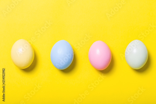 Canvas Print colorful easter eggs on yellow  background