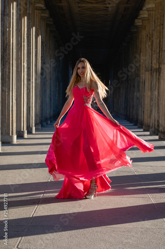 young woman in pink long dress