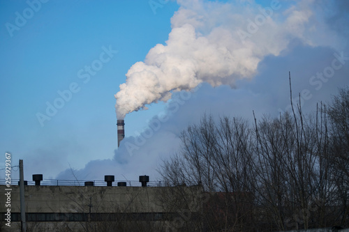 the pipes of the plant emit smoke and gas into the atmosphere.