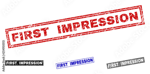 Grunge FIRST IMPRESSION rectangle stamp seals isolated on a white background. Rectangular seals with distress texture in red, blue, black and grey colors.