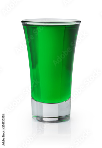 Green shooter in a shot glass on white background
