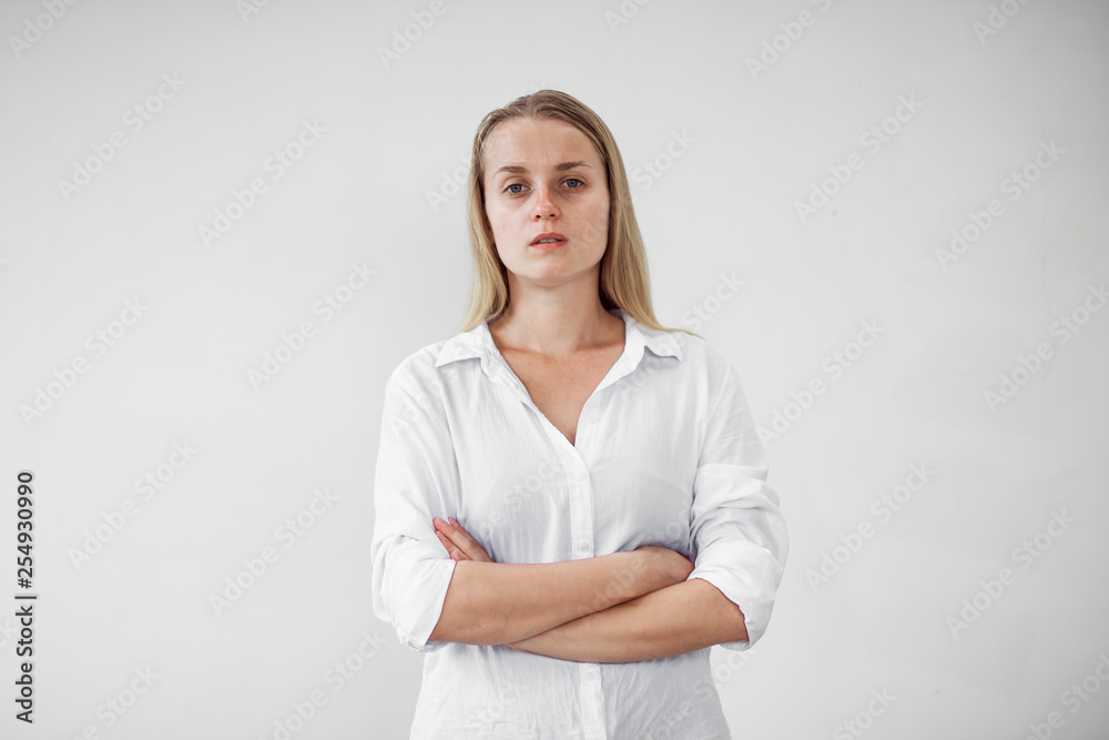 Portrait of a tired girl without makeup on a white background Portrait of a tired girl without makeup on a white background
