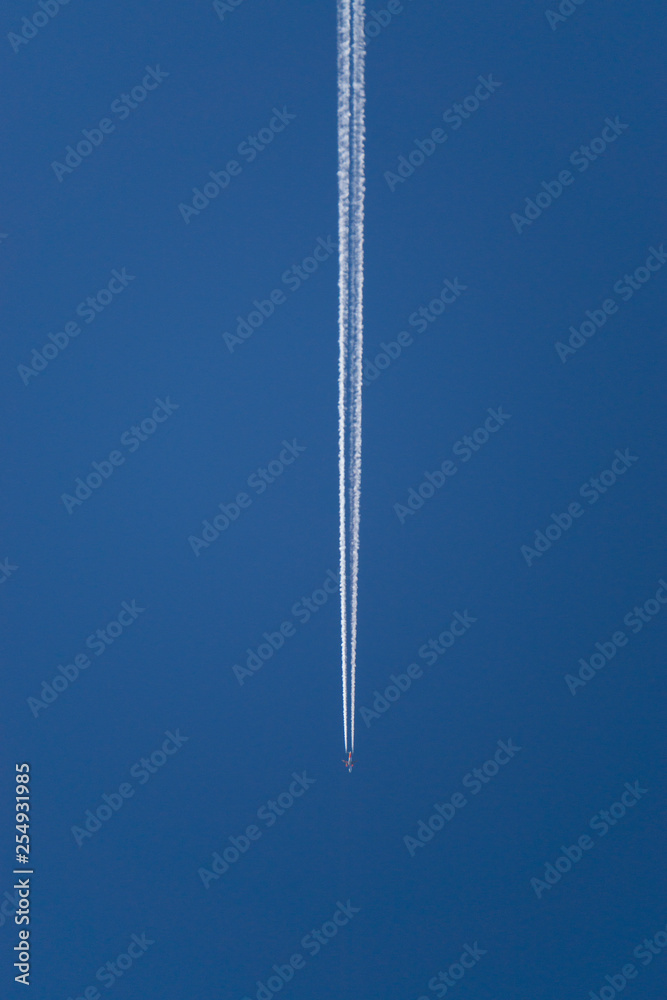 Aeroplane vapor trails in jet stream from jet aircraft. - obrazy, fototapety, plakaty 