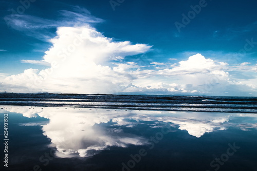 Scenery of the clouds in blue sky and sea with the beach in the evening time