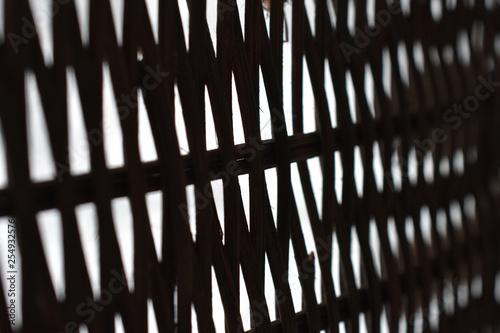 lattice of intertwined black rods on a white background in perspective