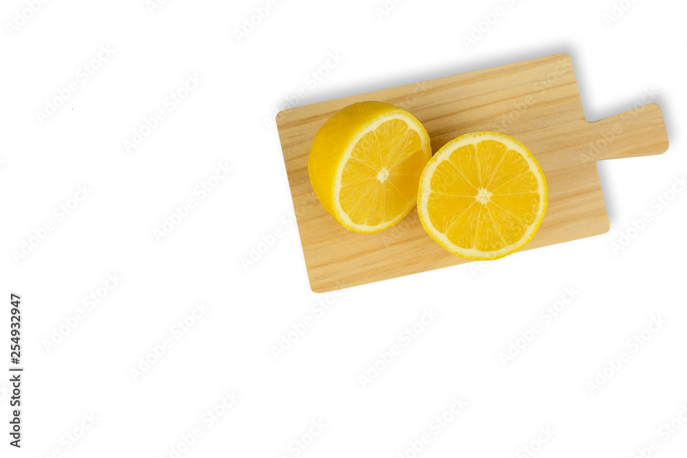 Fresh yellow lemons on wooden cutting board isolated on white background - image Fresh yellow lemons on wooden cutting board isolated on white background - image