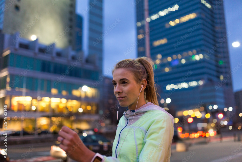 Female runner in city at night