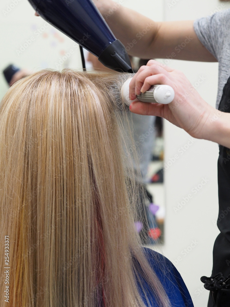 Naklejka premium Hair dryer drying after coloring. Beauty concept.