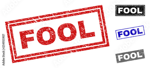 Grunge FOOL rectangle stamp seals isolated on a white background. Rectangular seals with grunge texture in red, blue, black and gray colors.