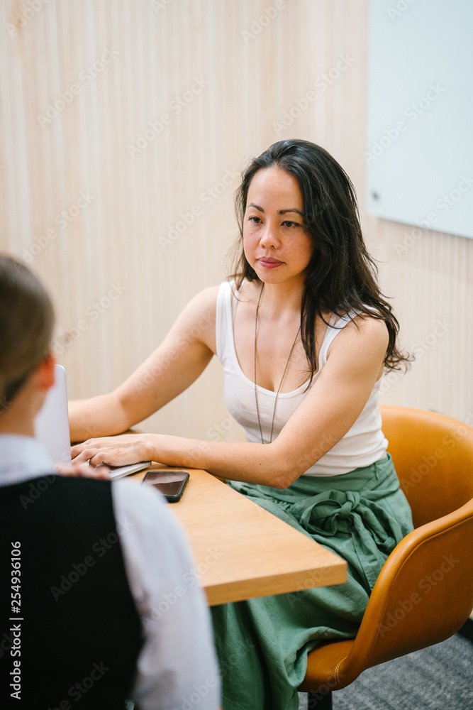 Two wonderful ladies discussing a story inside a room. They look extremely proficient in their office clothing. Two wonderful ladies discussing a story inside a room. They look extremely proficient in their office clothing.