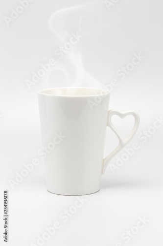 A white creamy cup with steam and heart symbol handle