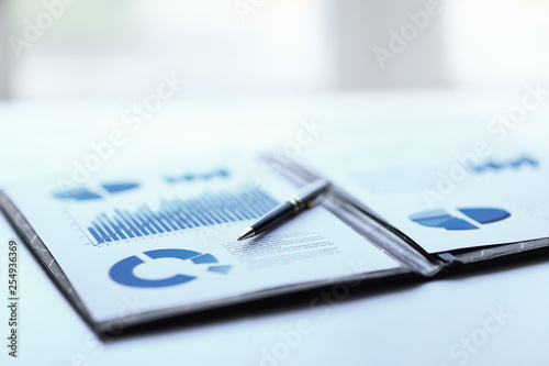 background image of a clipboard with financial report on table photo