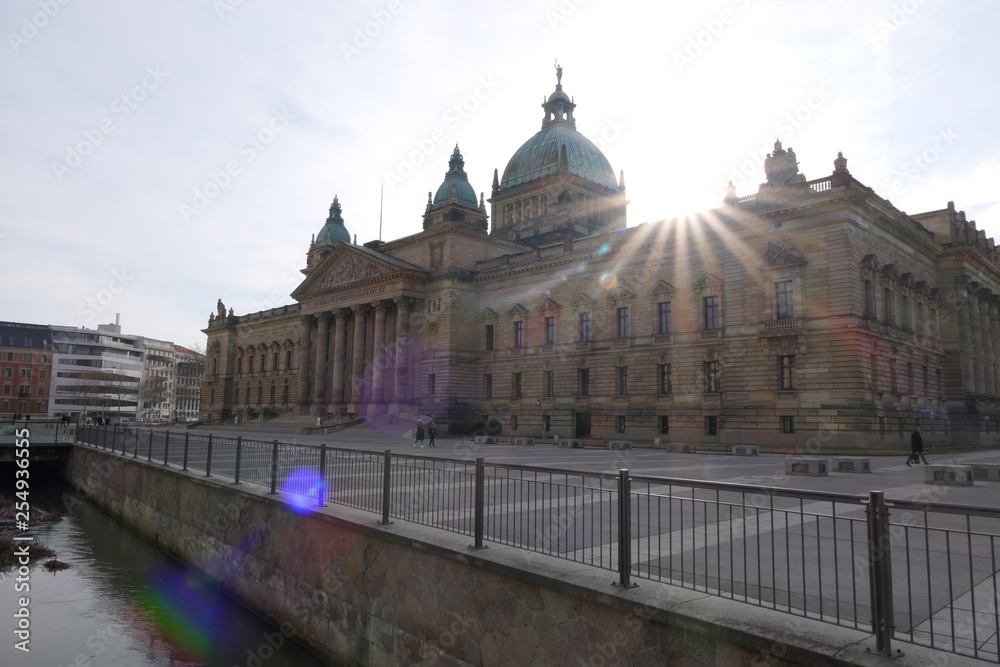 Front view to the whole place of the Federal Administrative Court (Bundesverwaltungsgericht) with the sun in the background in Leipzig, Germany
