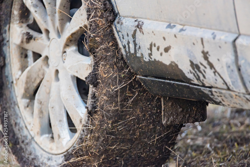 Close up dirty car with dry mud on tires