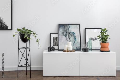 White sideboard and flower stand photo