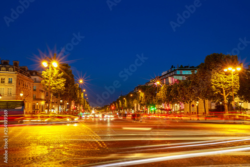 tourists at night in the most famous avenue in Paris of France, the Champs Elysees, known for luxury and shopping that starts from Place de La Concorde to Place Charles de Gaulle.