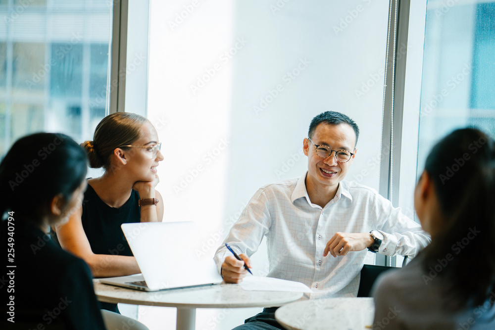 A group of professionals discussing a project inside a conference room. They are meeting up to finish a certain job in corporate attire and elegant dresses. A group of professionals discussing a project inside a conference room. They are meeting up to finish a certain job in corporate attire and elegant dresses.