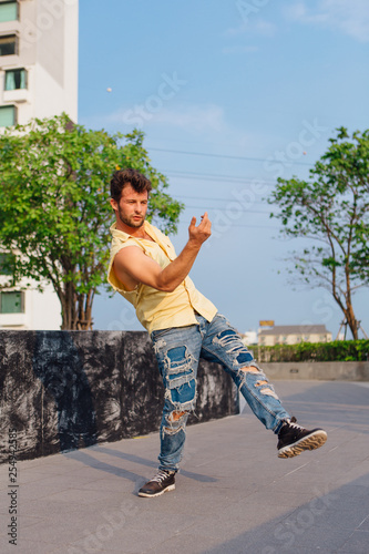 Young man dancing breakdance on the street. photo