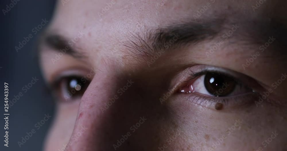 Extreme close up view of male brown eyes attentively focused on computer, gadget, device. Reflection, vision worsening, health concept. Working hard, modern technologies Extreme close up view of male brown eyes attentively focused on computer, gadget, device. Reflection, vision worsening, health concept. Working hard, modern technologies