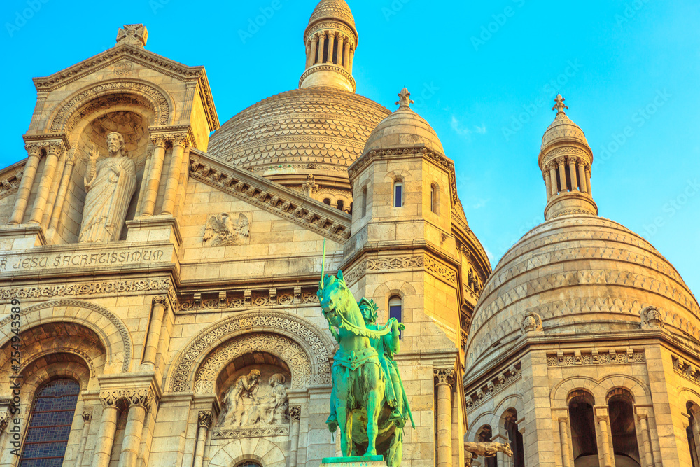 Detail of facade of Sacred Heart of Paris church in France. Basilique du Sacre-Coeur de Montmartre, the historic district of Paris Capital. Sunset light.