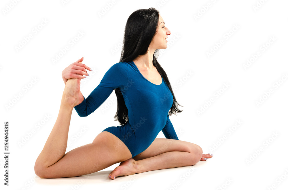 Beautiful slim girl in a blue bodysuit yoga trainer does assans. Beautiful slim girl in a blue bodysuit yoga trainer does assans.