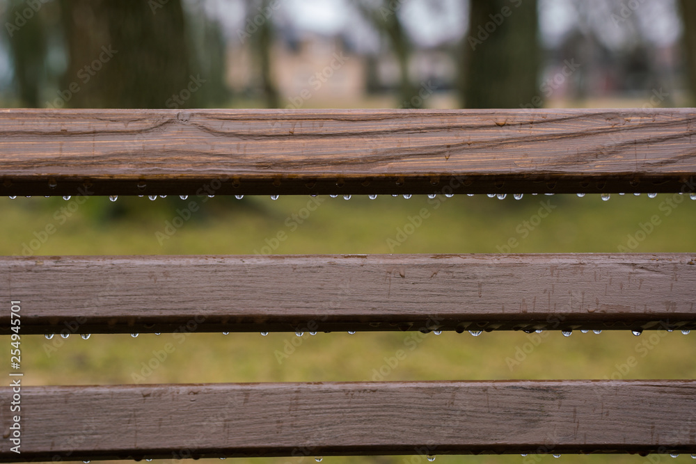 Rainy weather. Drops of water on the bench.