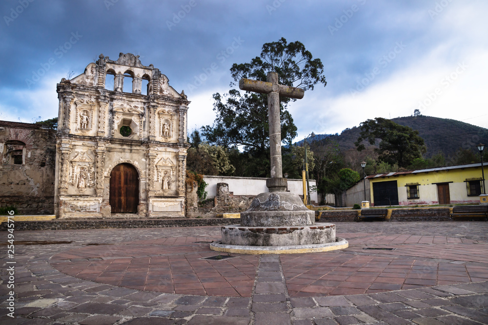 Church fassade ruin of Ermita de Santa Isabel and mountain with dramatic cloudscape, Antigua, Guatemala