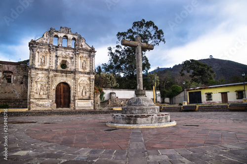 Church fassade ruin of Ermita de Santa Isabel and mountain with dramatic cloudscape, Antigua, Guatemala