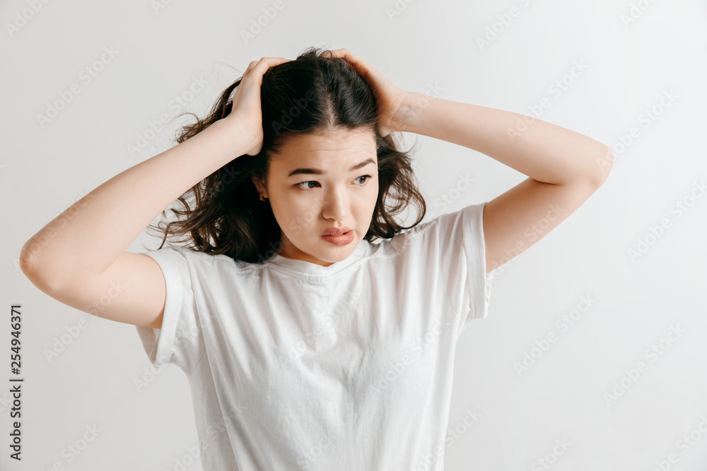 Why is that. Beautiful female half-length portrait isolated on gray studio backgroud. Young emotional surprised, frustrated and bewildered woman. Human emotions, facial expression concept. Why is that. Beautiful female half-length portrait isolated on gray studio backgroud. Young emotional surprised, frustrated and bewildered woman. Human emotions, facial expression concept.
