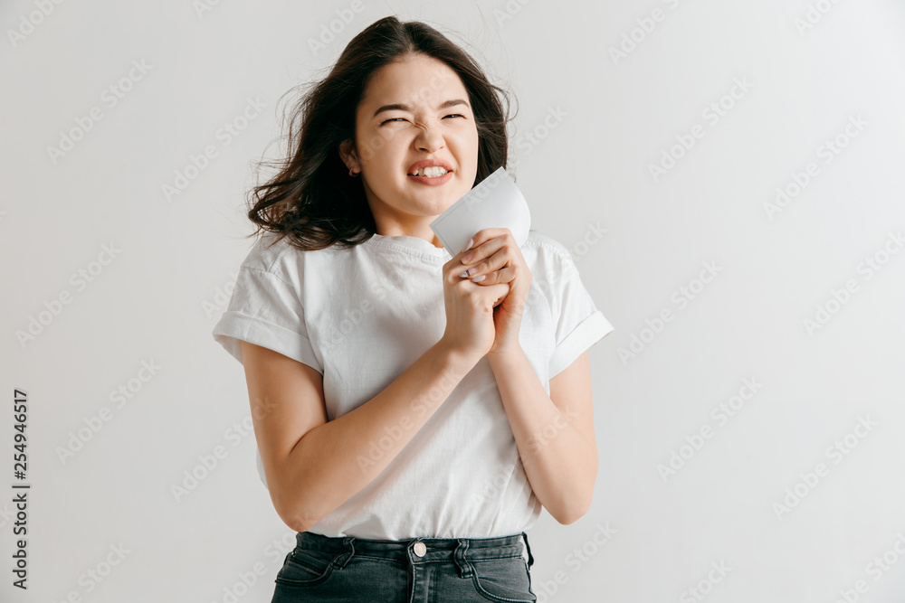 Young asian woman with a surprised happy expression won a bet on studio background. Human facial emotions and betting concept. Trendy colors Young asian woman with a surprised happy expression won a bet on studio background. Human facial emotions and betting concept. Trendy colors