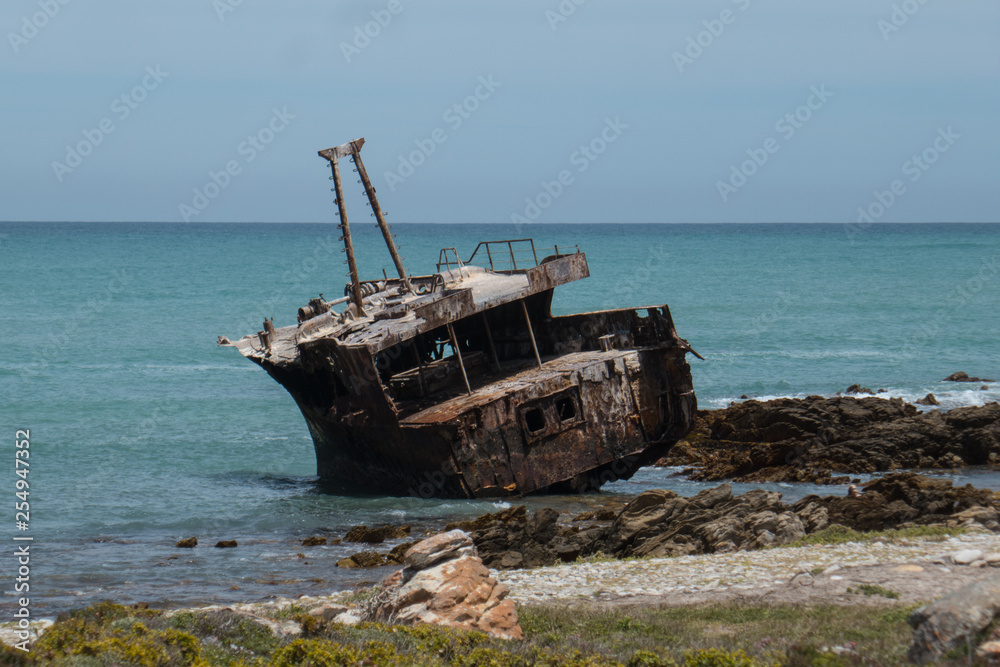Shipwreck at Cape Agulhas, the southernmost point of the African continent, where the Indian Ocean meets the Atlantic Ocean, Western Cape, South Africa.